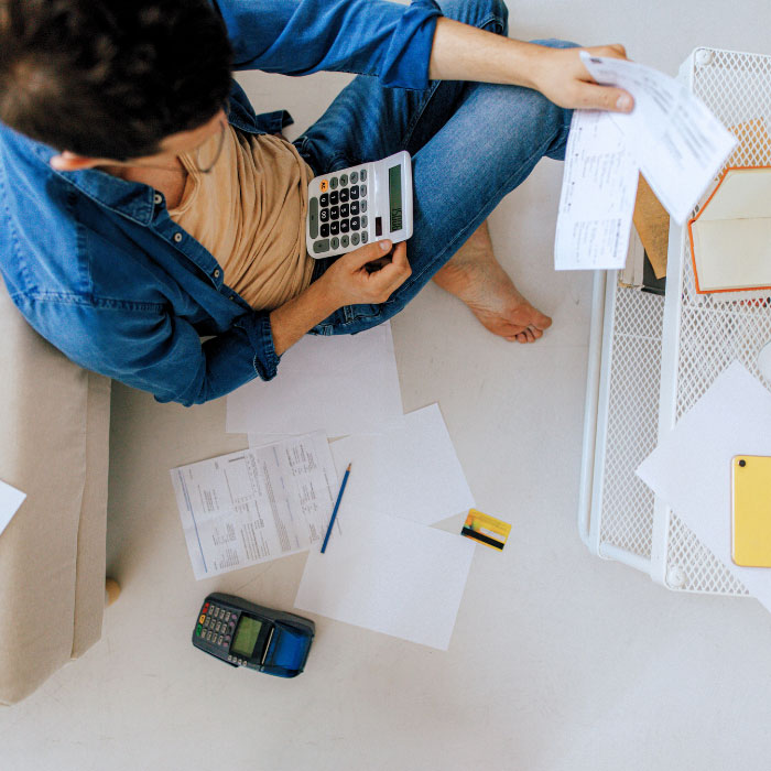 Man using a calculator to pay bills